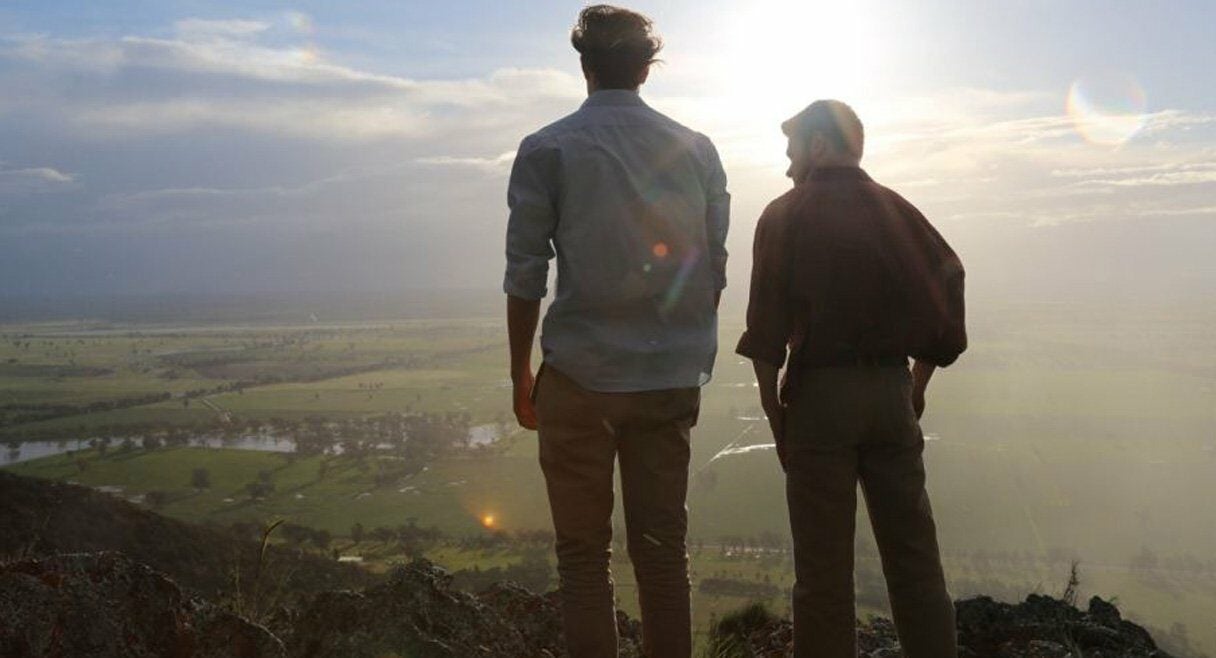 image of two brothers standing on a mountain looking out across a valley