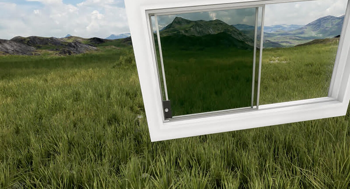 a window is floating on a field of green grass