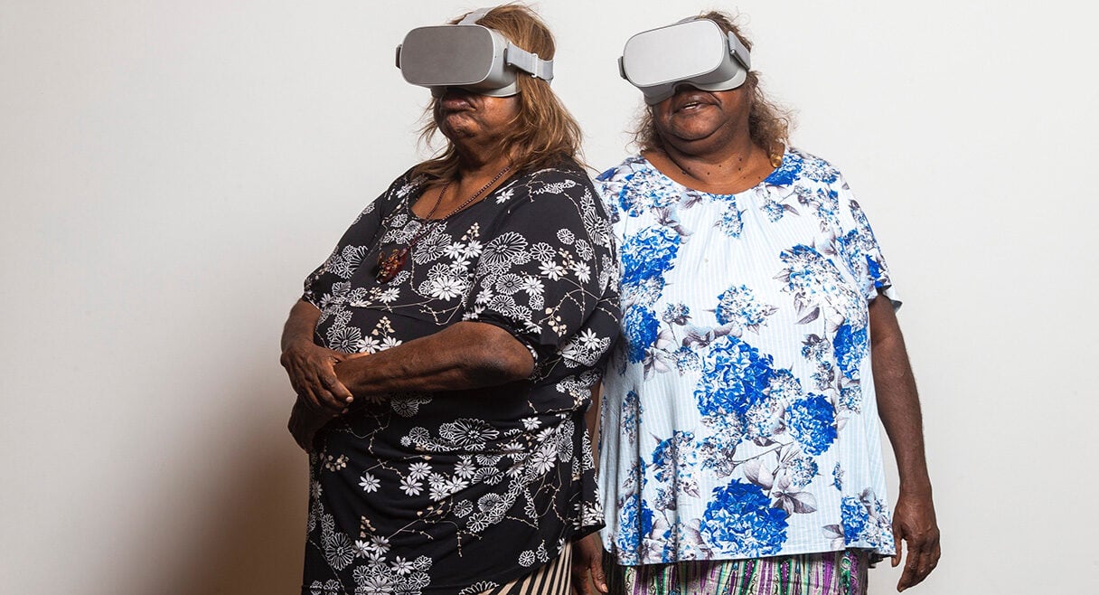 two indigenous women wearing VR headsets