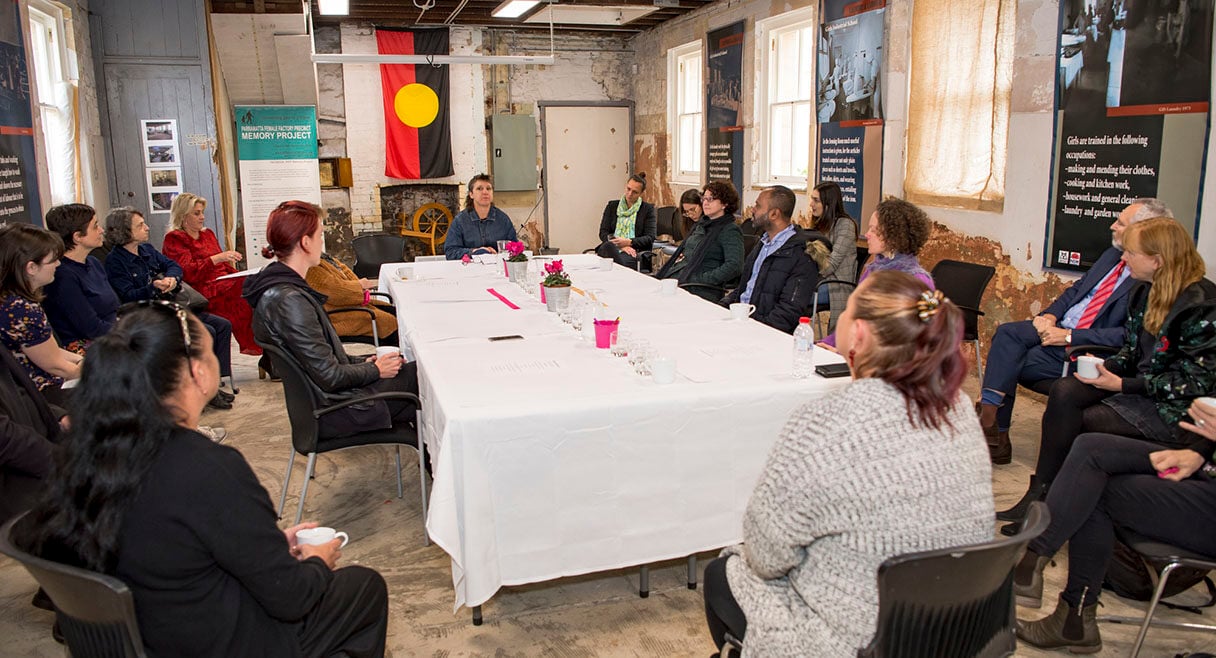 group of people sitting around a long table